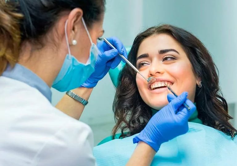 Paciente sonriente recibe un chequeo y limpieza de dientes realizada por un dentista profesional