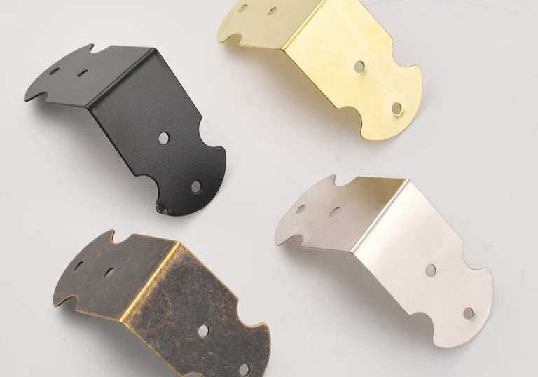 Decorative metal furniture corner protectors in black, gold, silver, and bronze finishes for table edge protection.