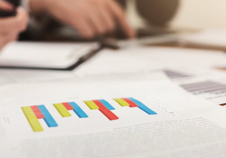 Professional business report showing colorful bar charts during a financial data analysis meeting.