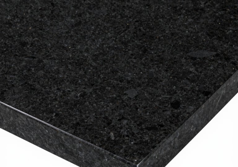 Professional studio photography of a polished black granite slab with subtle golden sparkles, high-contrast lighting reflecting the smooth premium surface.