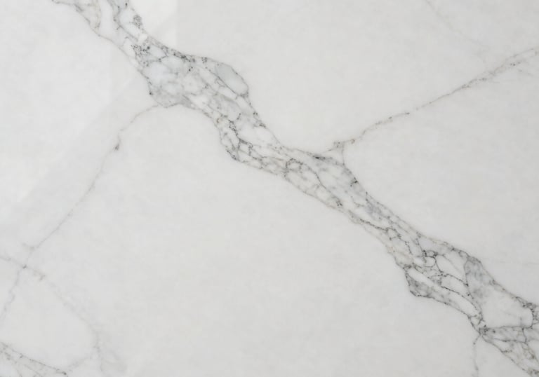 Overhead professional shot of a large polished white marble slab, showcasing delicate grey veining and a reflective clean surface, perfect for high-end flooring.