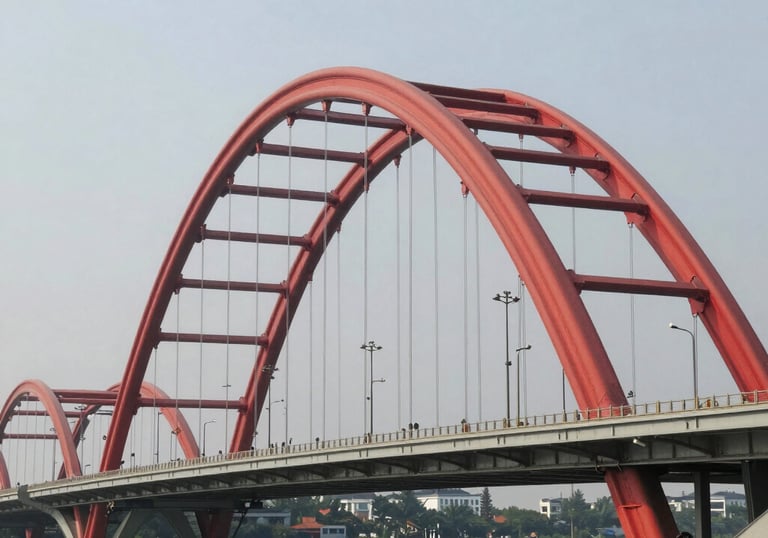 Close-up of a professional spray gun applying red paint on a metal surface.