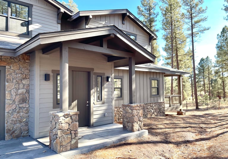 custom home with a stone exterior and a stone porch