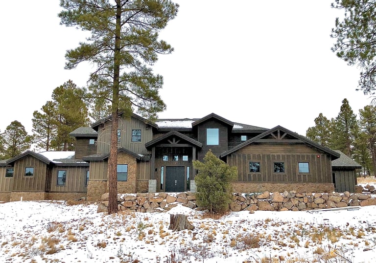 custom home in the mountains with rock wall 