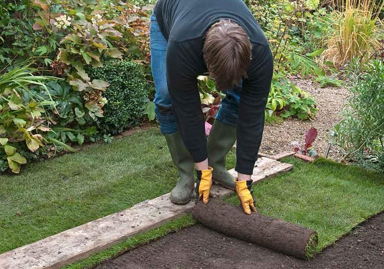 A Hedgie Wilder employee laying fresh turf in a garden in Markovo, Plovdiv.
