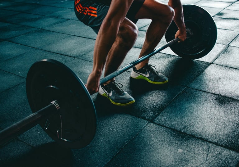 a man is squatting on a barbell