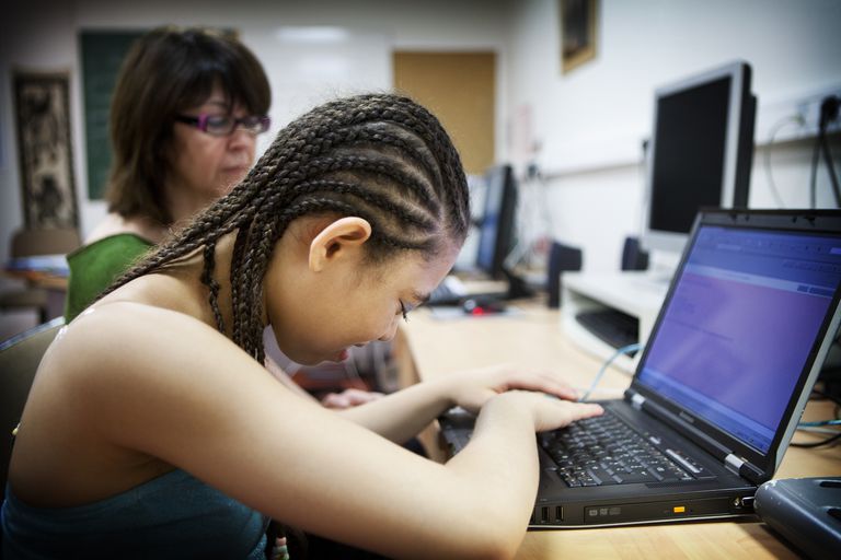 blind girl on laptop using apple accessibility settings voiceover screen reader for the disabled