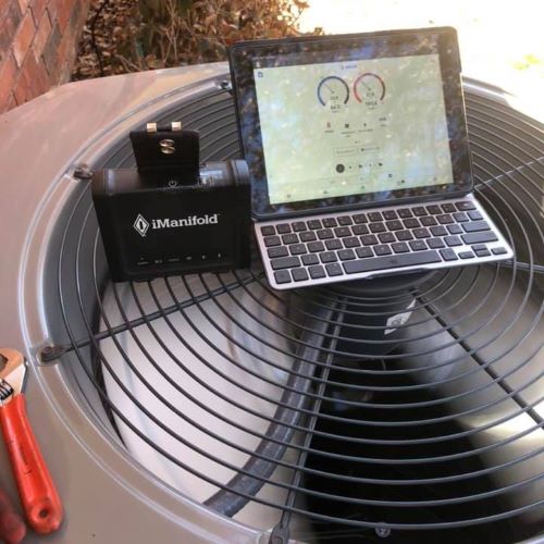 Our technician utilizing high end tools to  diagnose repairs on a residential home in Arli