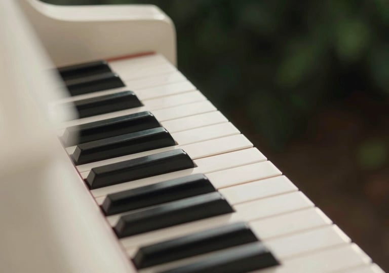Clean, minimalist shot of ivory piano keys with soft morning light and a hint of dark forest green in the shadows.