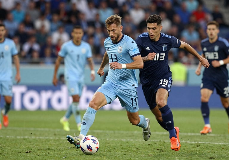 Competitive soccer match scene, high intensity, players in light blue and navy uniforms, sharp focus, professional sports photography.