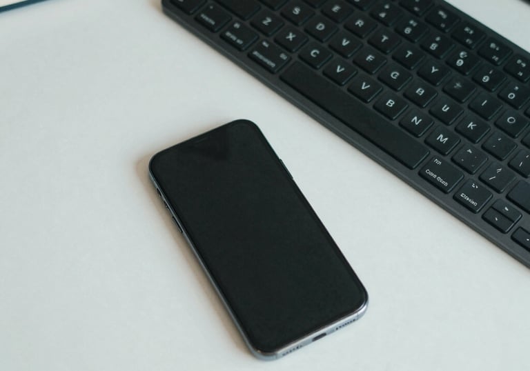 Top-down view of a clean, organized office desk with a smartphone, a high-end keyboard, and a notebook, professional and efficient aesthetic with muted teal tones.