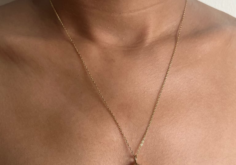 Delicate gold necklace with heart-shaped pendant