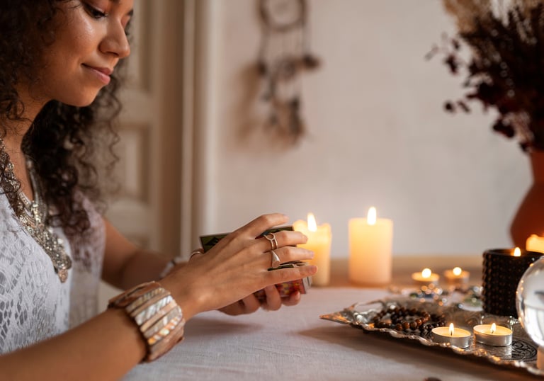 a woman sitting at a table with candles and candles