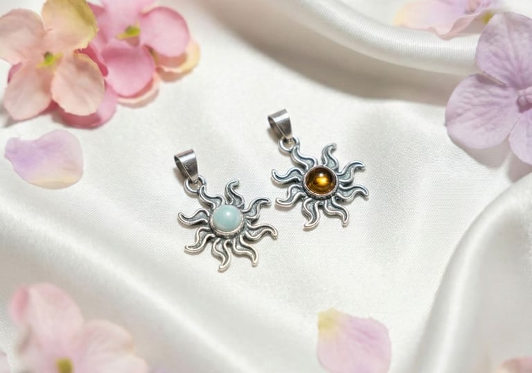 a pair of earrings with a flower on a white cloth