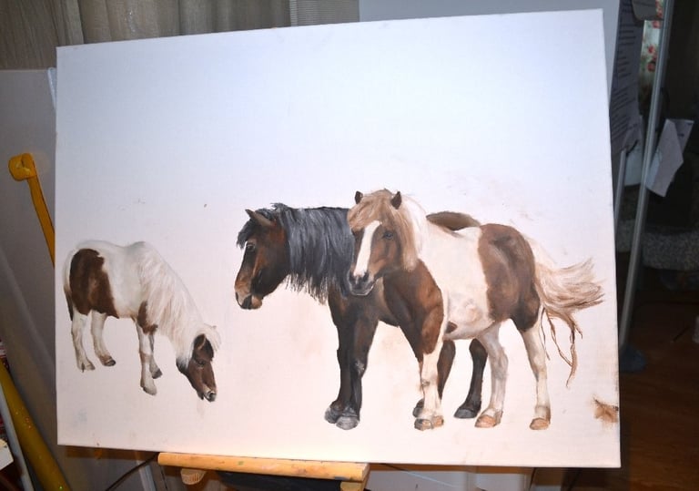 a painting of three ponies drawn on a canvas