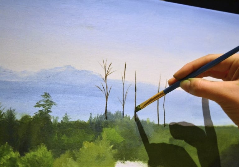 painting branches of trees against mountains