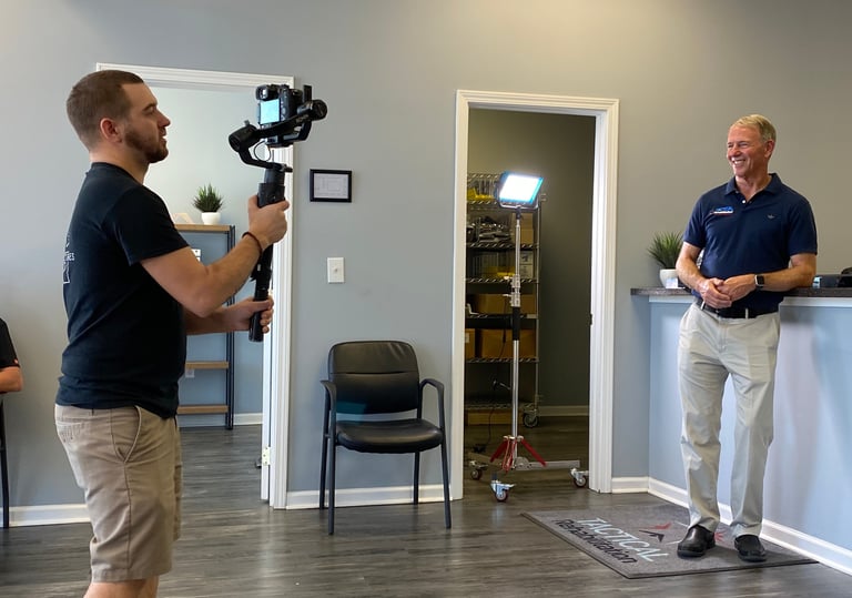 Jacksonville NC video producer Chris Lee filming on-location with professional gear.