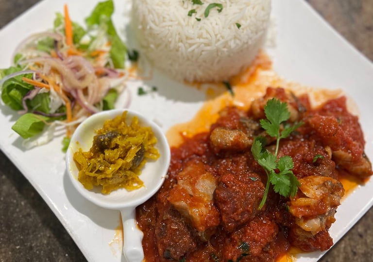 a plate of food with fish daube, rice and vegetables