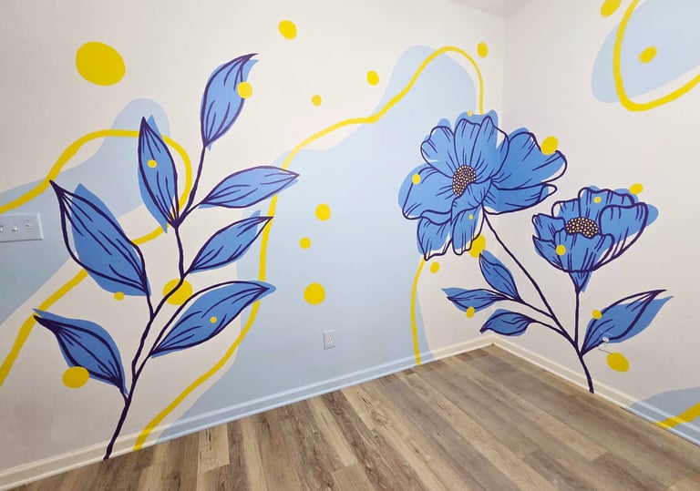 Modern floral wall mural with blue flowers, yellow accents, and abstract shapes in a room with wood floors.