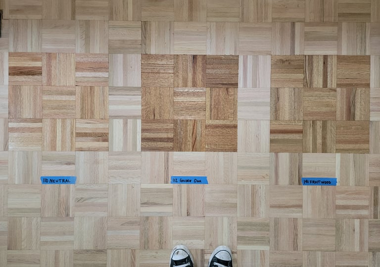 Stain samples on recently sanded parquet flooring.
