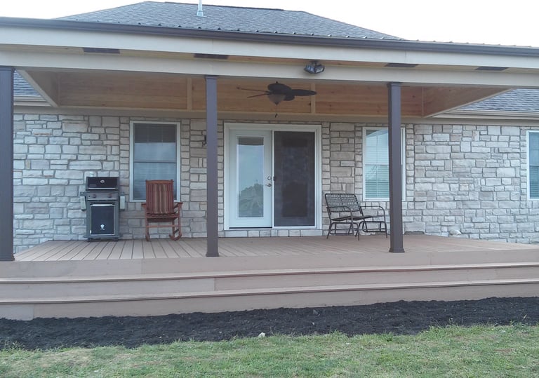 Covered composite deck with continuous steps and metal roof