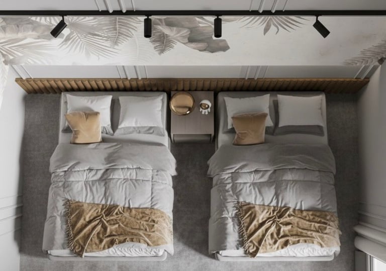 two beds in a bedroom with a wooden headboard Nour Nagy Designs