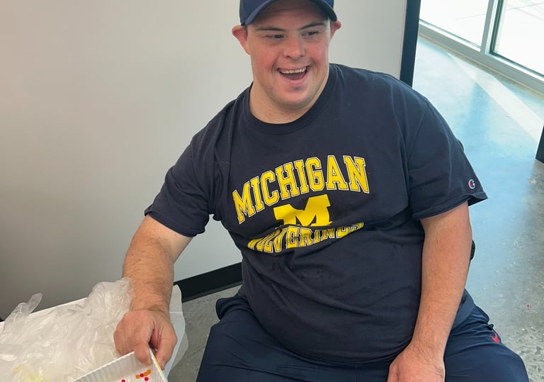 a man sitting at a table with a tray of food