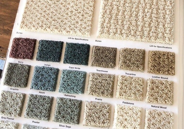 a book opened to show a selection of carpeting