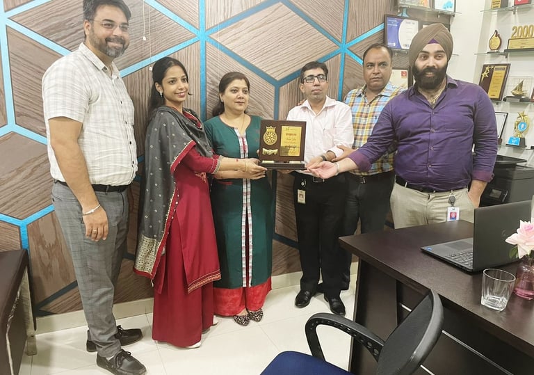 a group of people standing around a desk