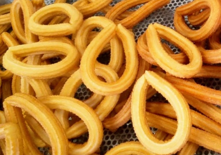 a bunch of churrons that are sitting on a metal mesh basket