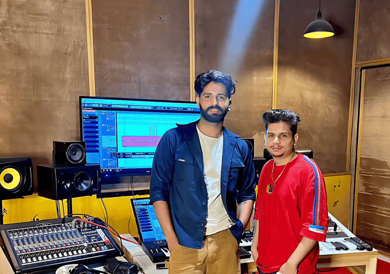 a man and a woman standing in a recording studio