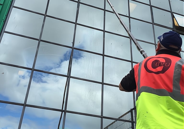 Window Cleaning long rech pole bieng used on commercial building in Exeter by C Thru Window Cleaners, Exeter.