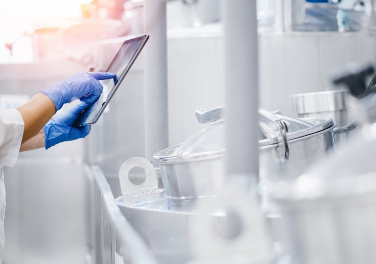 a person in a lab coat and gloves holding a tablet computer