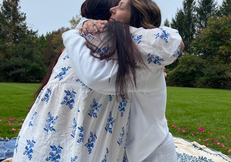 Two women embrace during ceremony