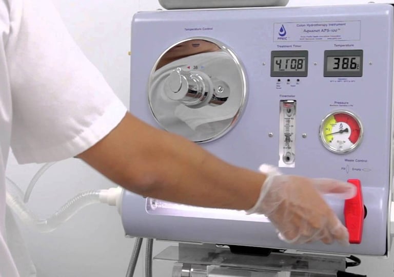 Professional colon hydrotherapy machine being operated by a technician for detoxification.