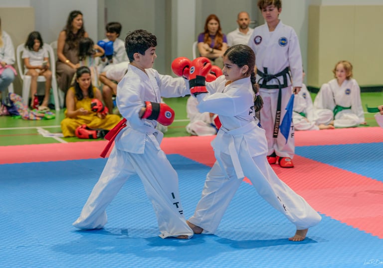 Junior ITF taekwondo students sparring in training match, Dubai