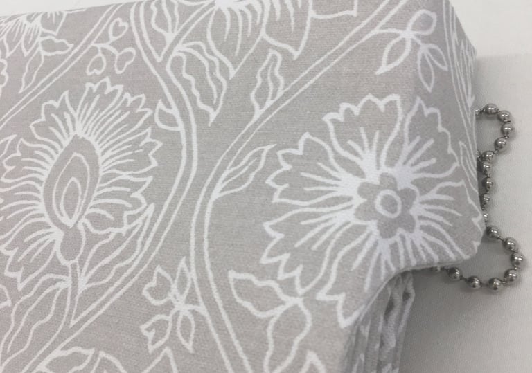 A roman blind with side tab to hide headrail