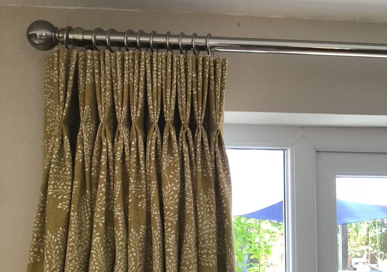 Curtains with stitched triple pleats in a yellow fabric chosen from one of my sample books.