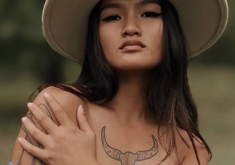 Woman posing in a tan cowboy hat