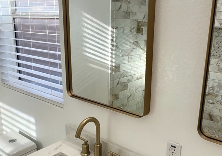 bathroom sink with gold faucet