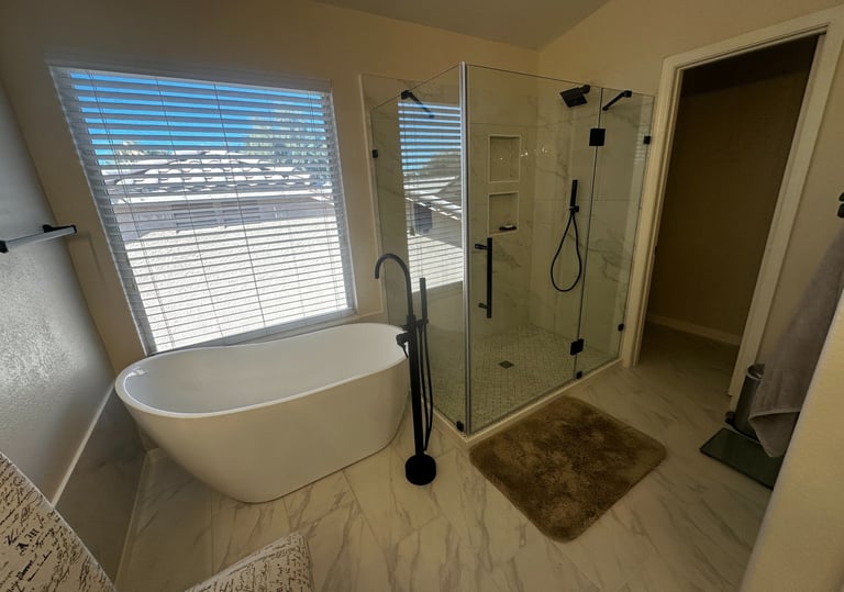 a remodeled bathroom with a stand alone tub and a walk in shower