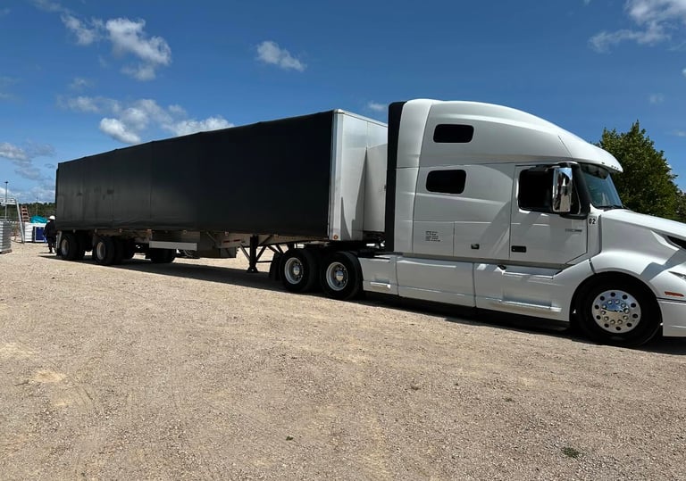 Transport Trucks on site delivering equipment to a festival.