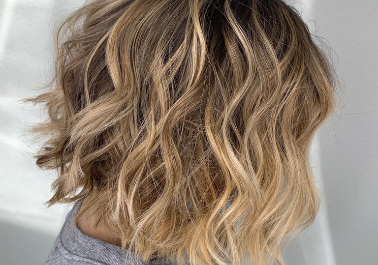 a woman with blonde hair and a grey shirt