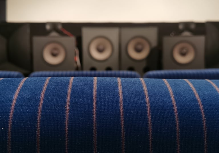 Hypnos Theatre's vintage cinema chairs and JBL speaker array.