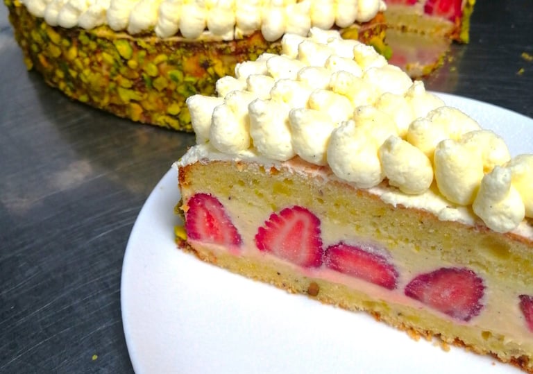 a strawberry cake with a slice of cake on top of it