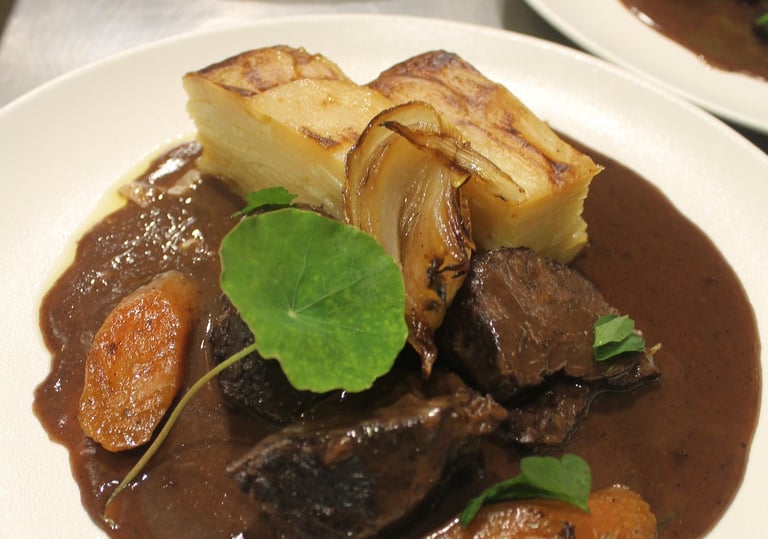 a plate of food with meat and vegetables