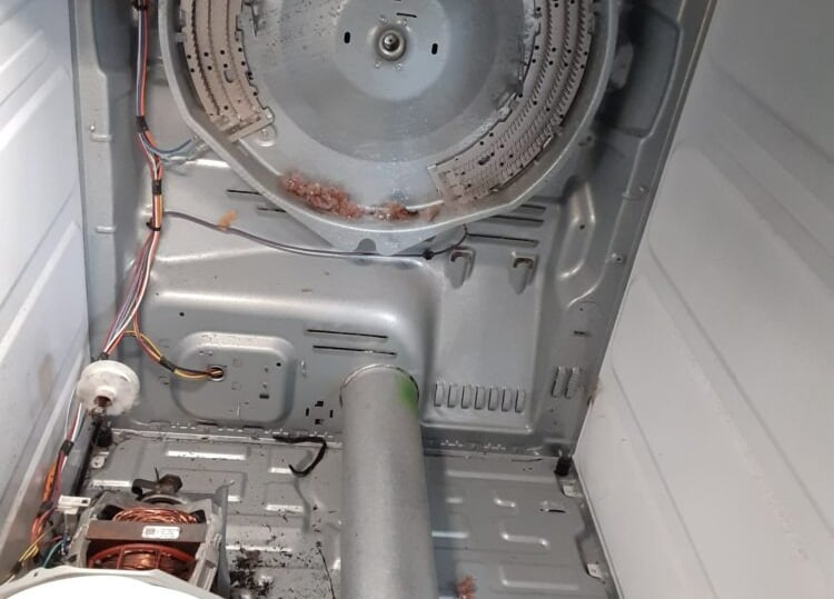 dryer taken a part and showing an exposed heating element