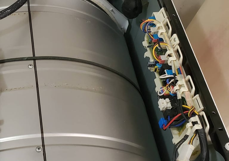 Opened dryer top revealing visible control board for repair.