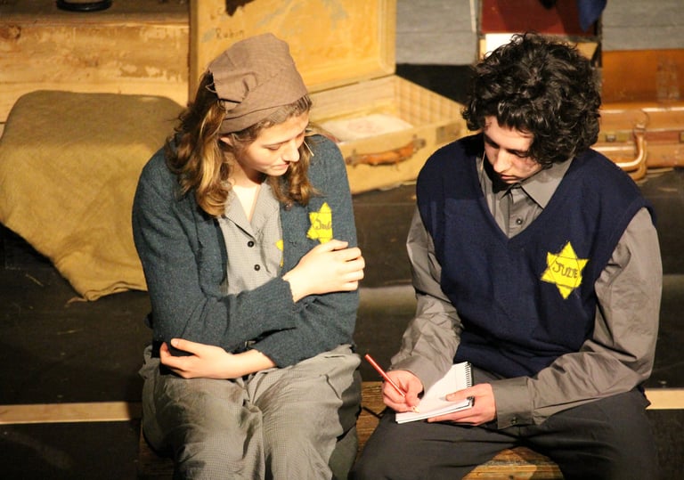 a man and woman sitting on a bench in a theatre