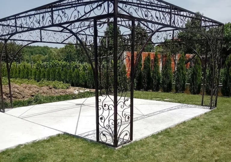 Elegant wrought iron garden gazebo with decorative scrollwork on a white patio base.
